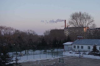 The basketball court in that school (with a northeastern sunset)