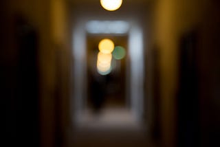 Blurry lights down an out-of-focus hallway. Worms All by Jim Latham