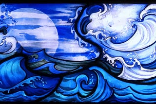 Horizontal panel of stained glass depicting waves in various shafes of blue with crisp, black outlines.