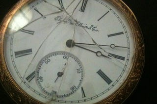 Gold pocket watch with broken crystal