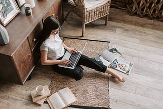 brand journalist on laptop sitting on floor