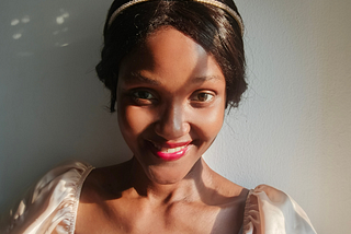 Black woman smiling with shadow on her face