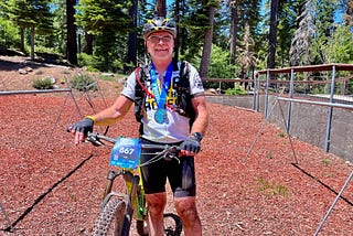 Man smiles after finishing mountain bike race