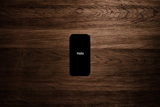 Simple white text that says “Hello” on a black iPhone background