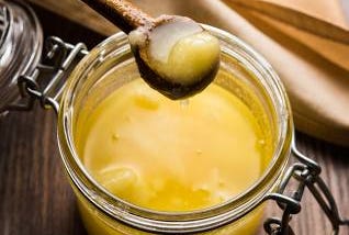 A jar of ghee with spoon