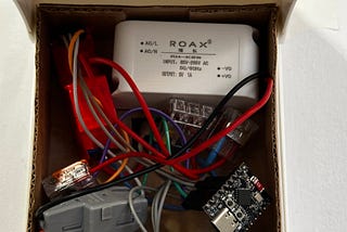 A mains-powered ESP32-based smart thermostat installed on the wall
