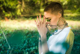 A woman practices spiritual prayer.