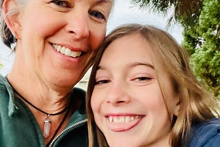 Photo of author and her daughter — both have blonde, medium-length hair and are smiling, daughter is 12 and sticking out her tongue playfully.