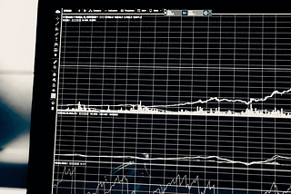 Black and white photo of a computer screen with charts and graphs