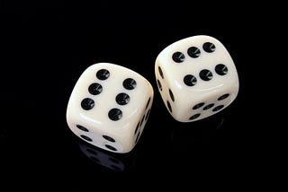 The image of two photoreal dice on a black background