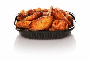 Plastic container with takeout chicken wings