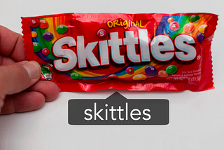 A package of Skittles candy with an Instagram tag on top of it that says “Skittles.”