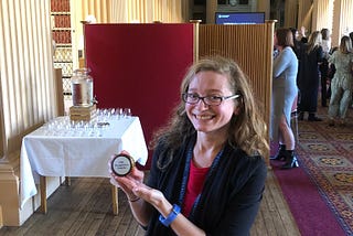 Me holding a cupcake that says USG Recognition Awards.