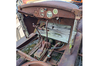 The vehicle in the photo is one I took at my mechanic’s place of a Star Car by Durant Motors, circa late 1920s. It shows the front seat area, though the seats are missing. It is quite rusty and many of the floorboards (which are actual wooden boards) are missing, too.
