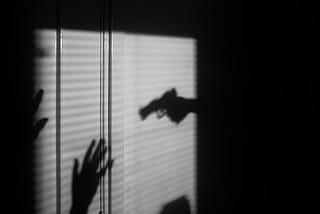 Shadow of a gun on a wall
