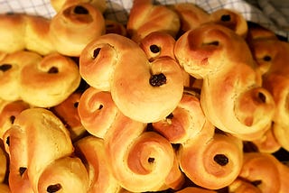 Yellow buns with raisins allegedly in the shape of cats.