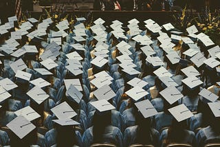 arial view of the tops of graduating class’s heads wearing mortar boards. Your graduating child