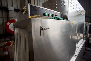 Photo Description: Image of an industrial dishwasher courtesy of Unsplash