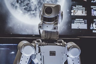 Robot in front of a screen showing the earth from space