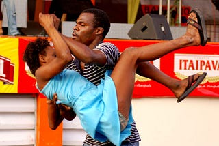 A man lifts a woman off the ground during a dance of Forró