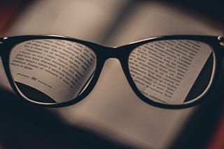 glasses revealing the written content of a book