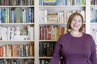 Color photo of novelist Jennifer Weiner with books
