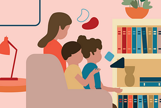 A mom and two kids sitting in front of a bookcase.