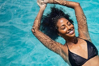 Be the Counterweight: Black woman in bikini floating in water. Photo credit Ridofranz on iStock photos.