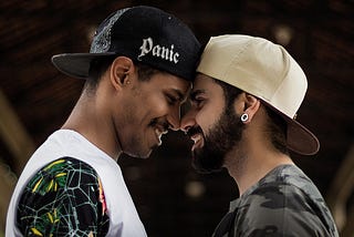 Gay male couple photo shoot with beard and noses touching