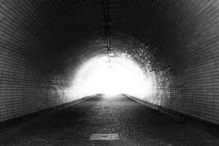 A tunnel with the exit ahead.