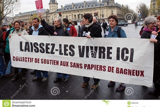 French protestors marching against restrictive immigration laws.