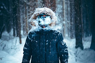 Picture of person with a mask in snow.