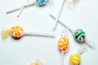 Colorful lollipops scattered against a white background