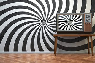 A wall painted with black and white “hypnosis” spirals and an old TV set displaying the same pattern.