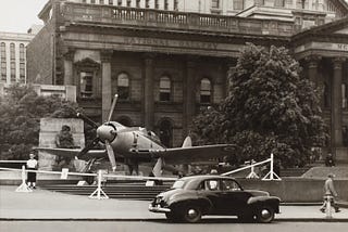 Photo of an airplane parked by a car.