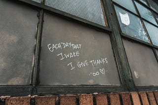 Each day that I wake I give thanks — written on a window