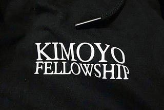 A Kimoyo Fellowship Hoodie with the Kimoyo Fellowship Printed on it.