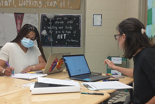 Photo of Livingston co-teachers Ms. Alexis Kelly-Darby (left) and Ms. Julia Fonshell (right) during their English 1 co-planning meeting with Dr. Watts-Freeman (not shown).