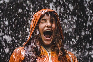 A girl shouting in the storm and rain.