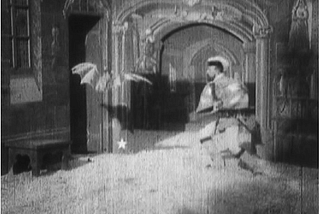 A scene from world’s first horror film Le Manoir du Diable, A man confronts a scary bat.