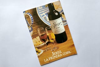 A poster with a bottle of Sherry and two glasses.