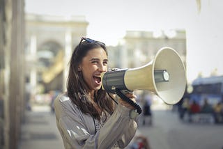 A girl announcing something on a loudspeaker