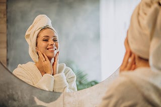 Skin care in the morning woman applying cream mask