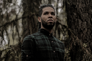 Attractive man in dense forest.