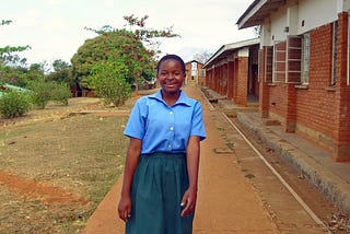 Secondary student Fanny outside her school