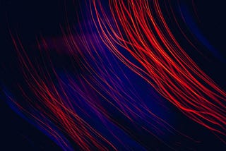 strands of red and blue wire against a black background