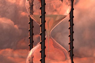 An hourglass on pink background