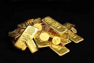 A pile of gold bars and coins