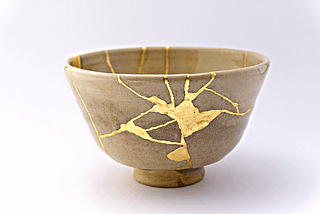 Kintsugi: pottery that used to be broken but is now put back together with gold at the fracture points