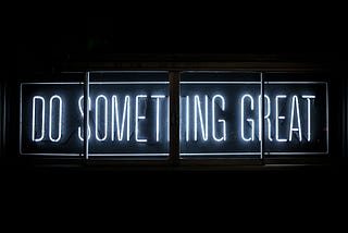Bright neon sign reading: “DO SOMETHING GREAT”
